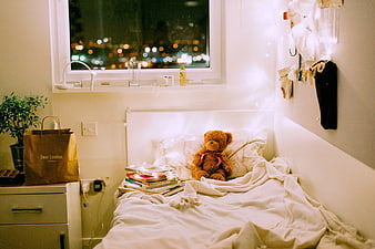 Cozy Bedroom Interior with Teddy Bear and City Bokeh