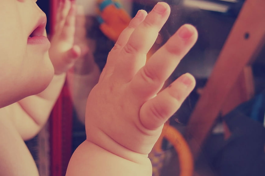 Close-up of Baby Hand Pressed Against Glass