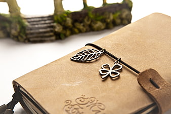 Vintage leather journal with metal leaf and clover charms