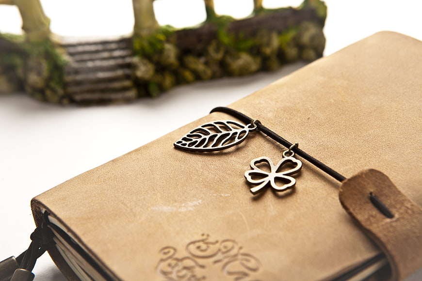 Vintage leather journal with metal leaf and clover charms