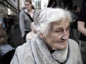 Close-up portrait of elderly woman with white hair and fur collar