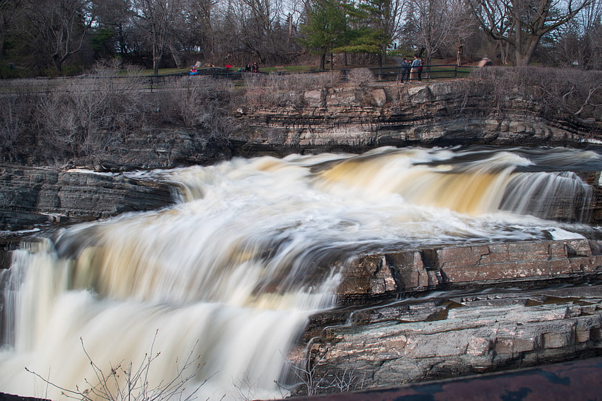 Long Exposure Waterfall Flowing Over Layered Rocks in Nature