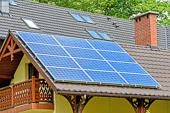 Solar panels on a residential roof with wooden balcony