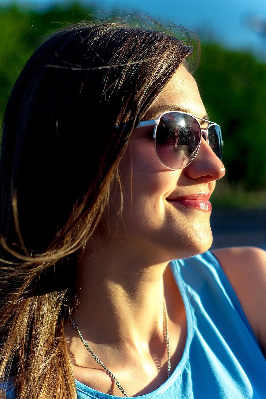 Smiling Woman in Sunglasses Outdoors