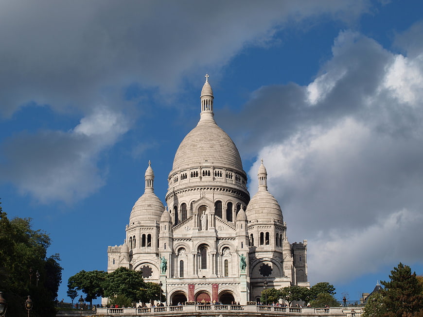 Sacré-Cœur Basilica in Paris against dramatic blue sky