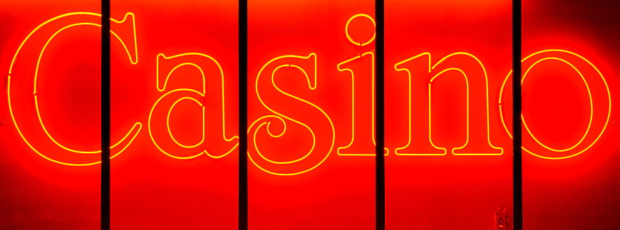 Red Neon Casino Sign With Yellow Lettering