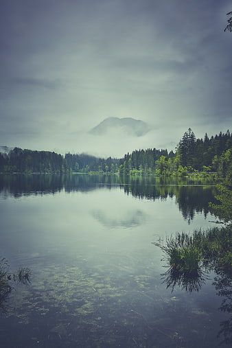 Serene Misty Mountain Lake with Forest Reflection