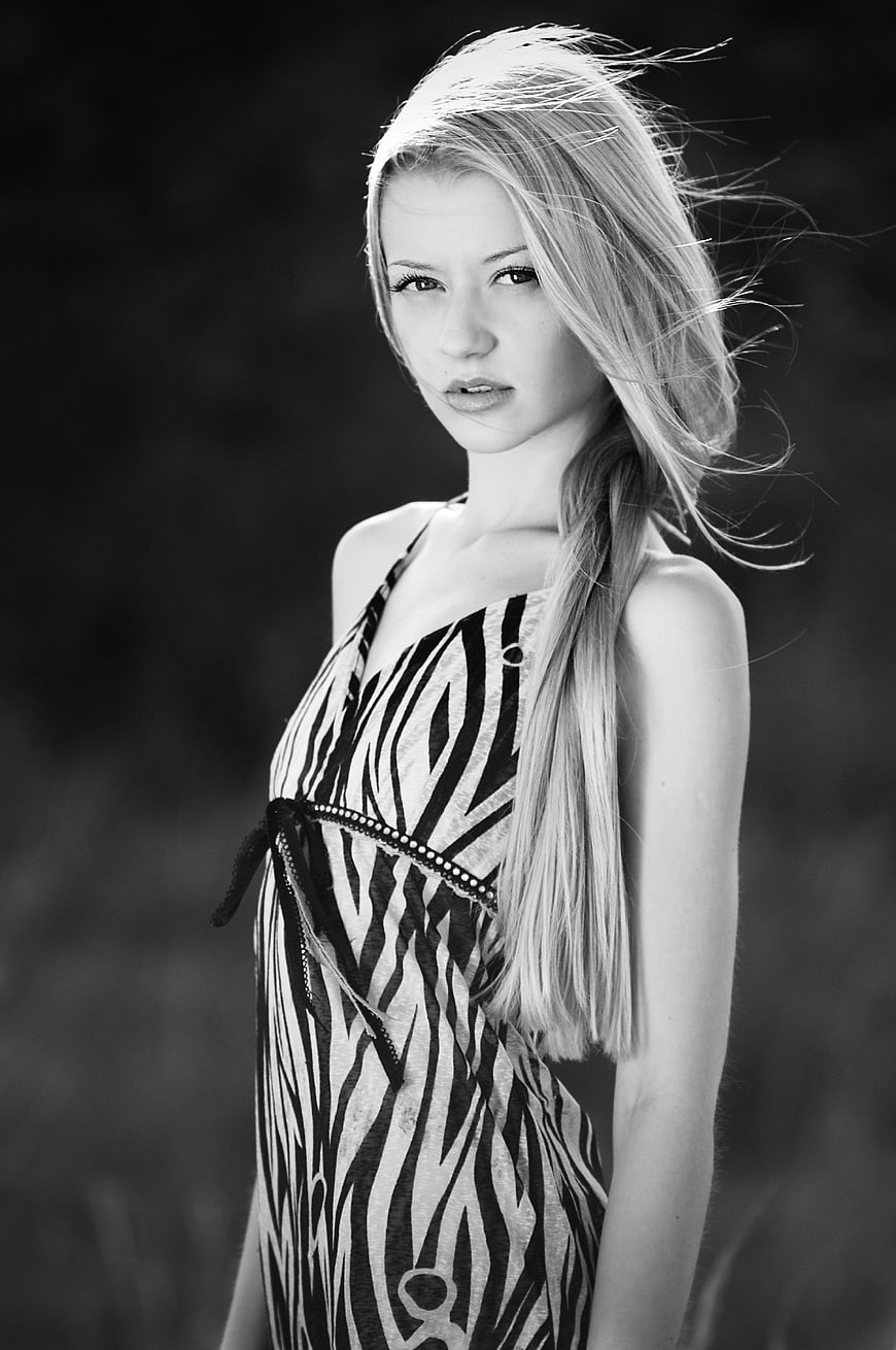 Black and white portrait of young blonde woman in zebra print dress
