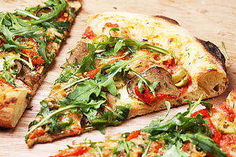 Freshly Baked Pizza Slices with Arugula and Mushrooms