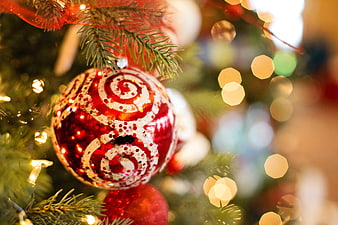 Red Christmas Ornament With Glittery Swirls And Bokeh Lights