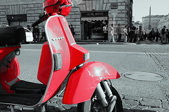 Red Vespa Scooter in Black and White City Square