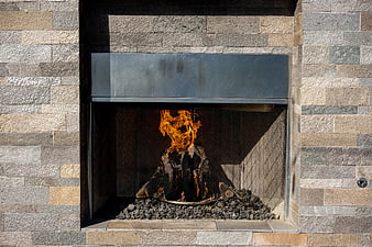 Modern Outdoor Stone Fireplace with Burning Fire