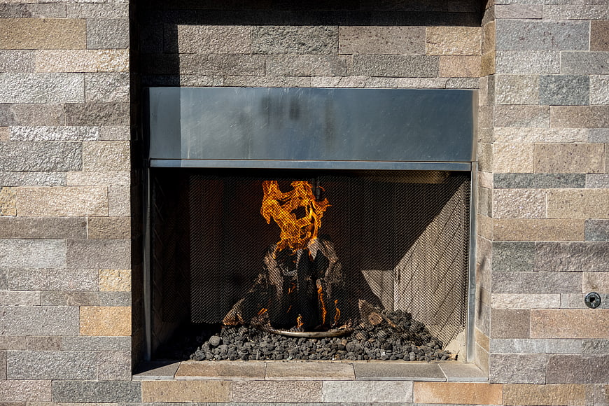 Modern Outdoor Stone Fireplace with Burning Fire