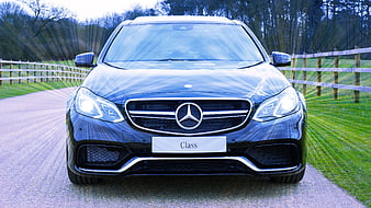 Front view of blue Mercedes-Benz E-Class on country road