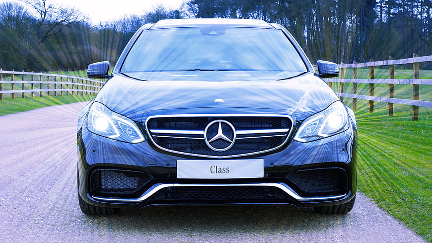 Front view of blue Mercedes-Benz E-Class on country road