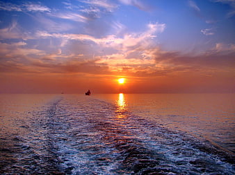 Ocean Sunset With Ship Wake And Sun Reflection On Water