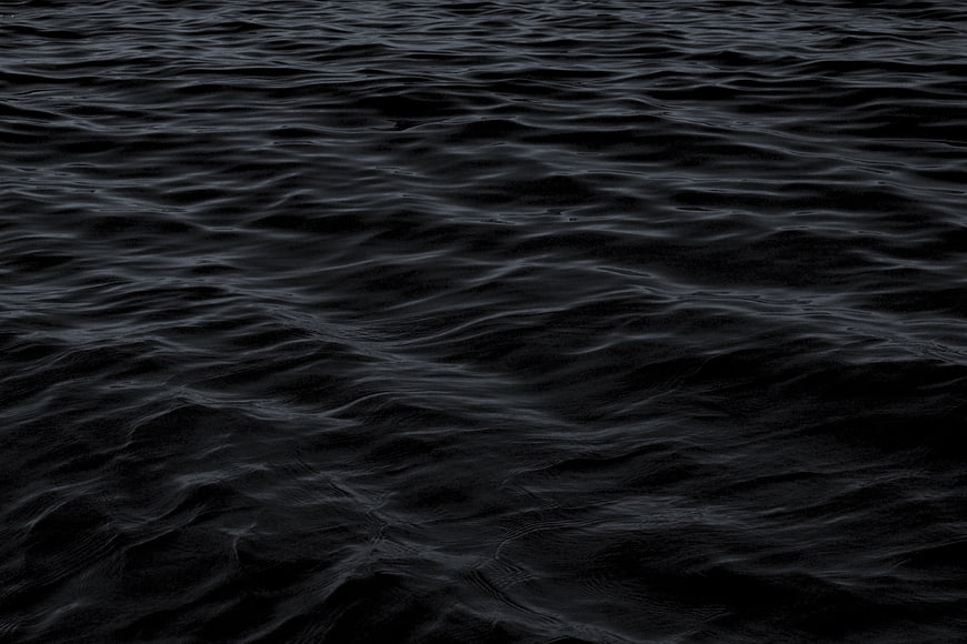 Dark rippling water texture background
