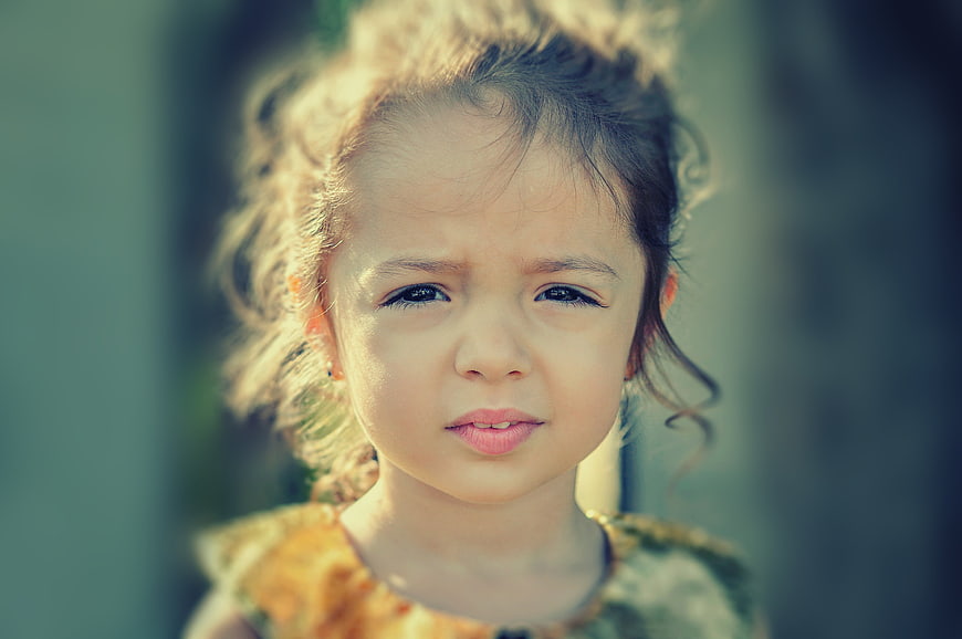 Close-up portrait of a young girl with a worried expression