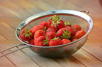 Fresh Ripe Strawberries In Metal Strainer On Wooden Table