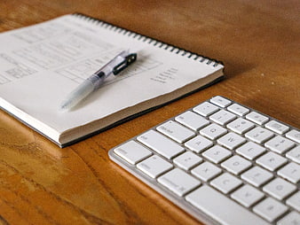 Minimalist Workspace with Keyboard and Notebook