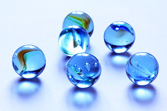 Blue Glass Marbles on White Background