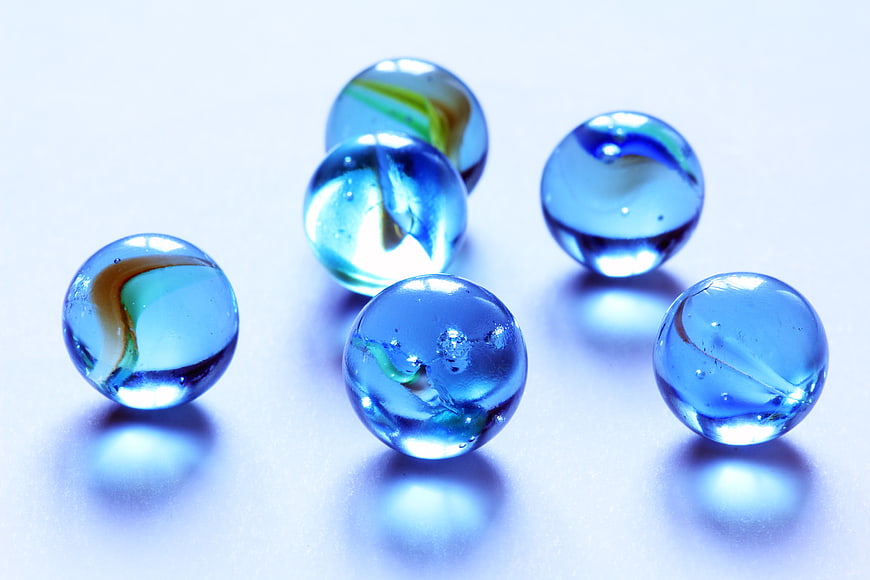 Blue Glass Marbles on White Background