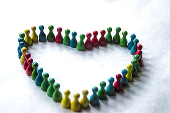 Colorful wooden game pieces arranged in a heart shape