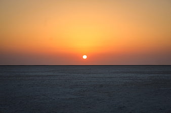 Serene Sunset Over Calm Ocean Horizon
