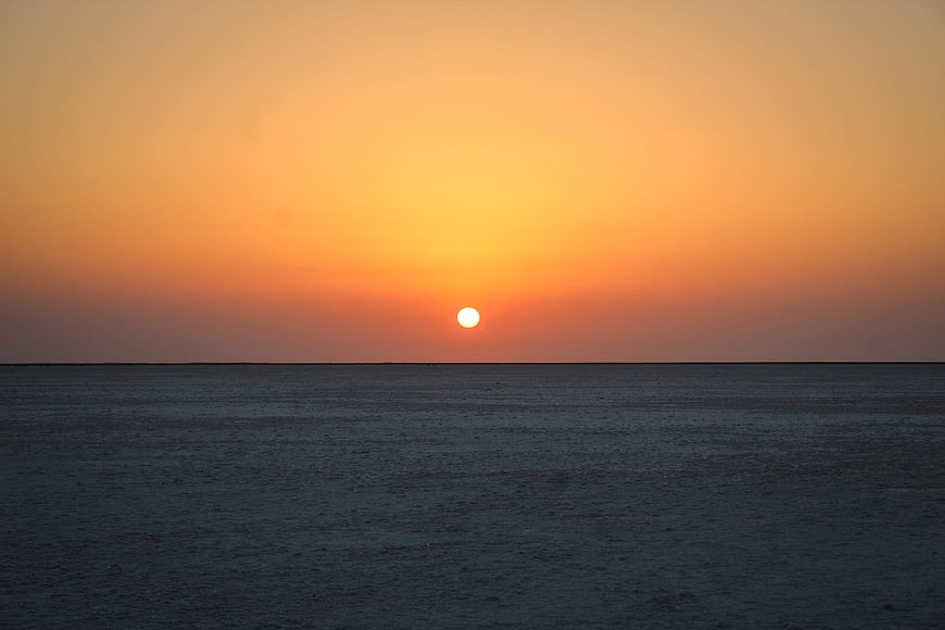 Serene Sunset Over Calm Ocean Horizon