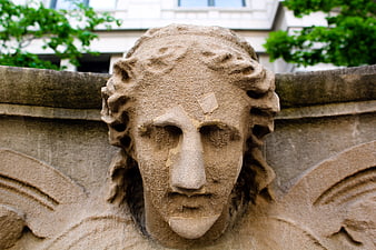 Close-up of weathered stone angel sculpture head