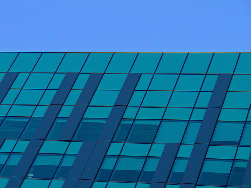 Modern Blue Glass Building Facade with Geometric Pattern