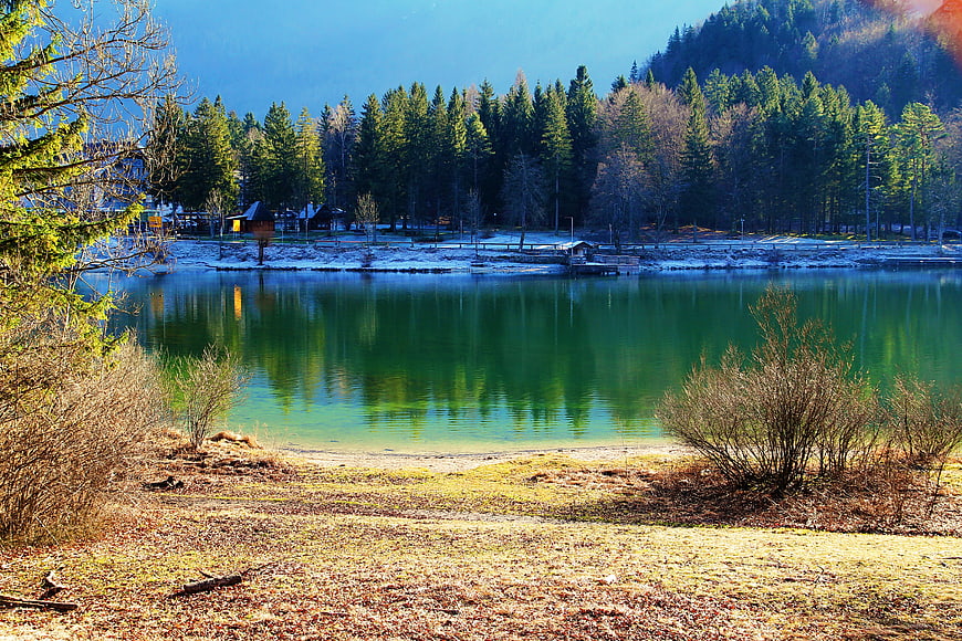Serene Alpine Lake with Emerald Water and Forest Reflections