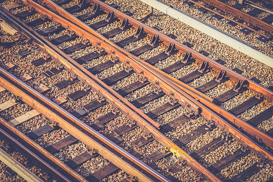High angle view of rusty railroad tracks and gravel