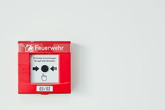 Red German Fire Alarm Call Point on White Wall