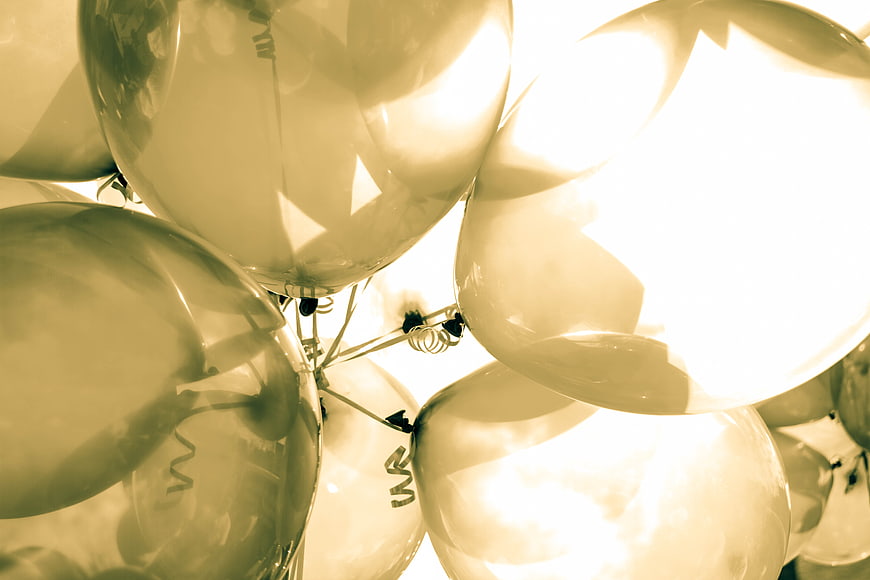 Close-up of shiny silver balloons with warm vintage filter