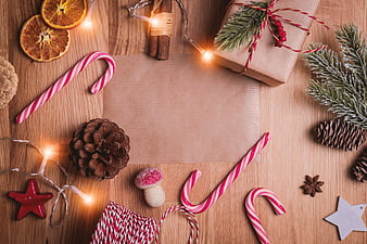 Christmas Flat Lay With Candy Canes, Pinecones, and Kraft Paper Gift