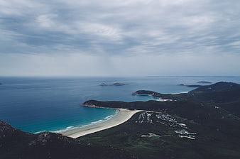 Aerial view of turquoise bay and white sandy beach coastline