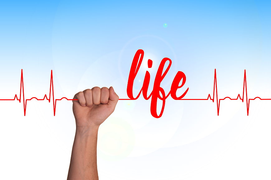 Hand holding red ECG line with life text on blue gradient background
