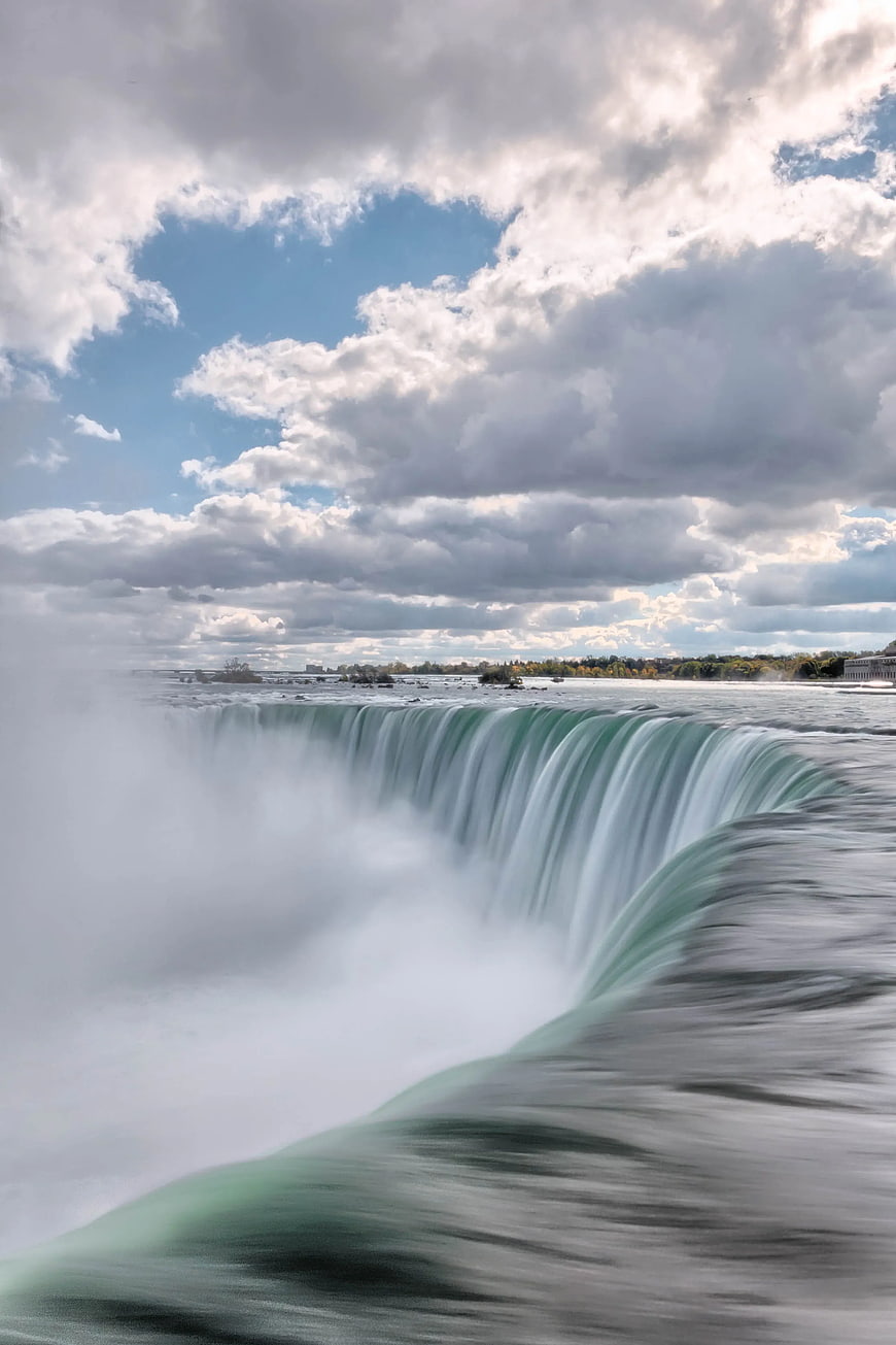 Majestic Niagara Falls Waterfall with Dramatic Cloudy Sky