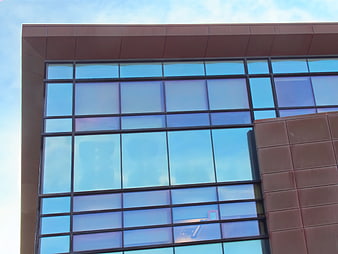Modern building facade with blue glass windows and brown panels