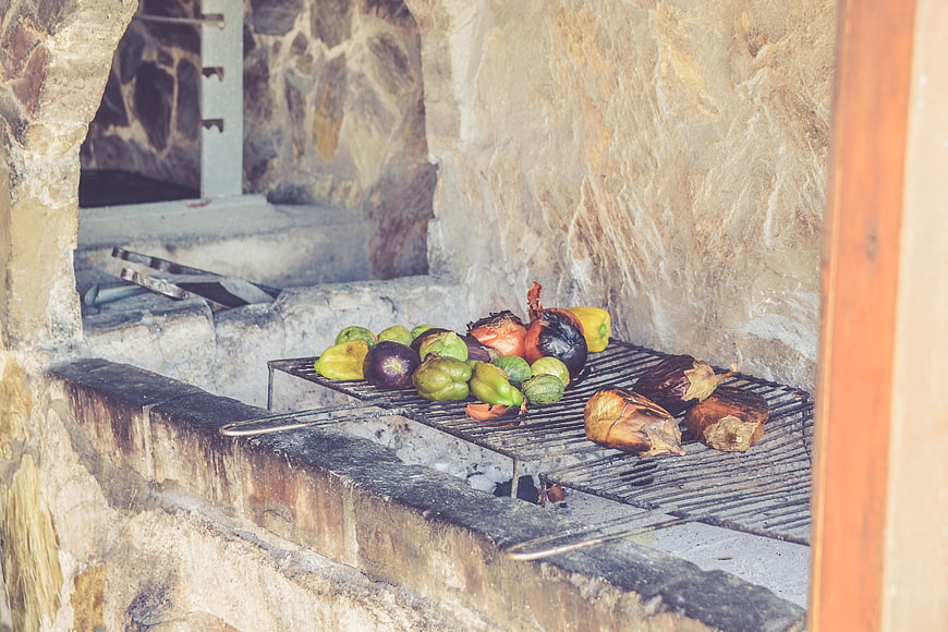 Grilled vegetables on a stone oven grate