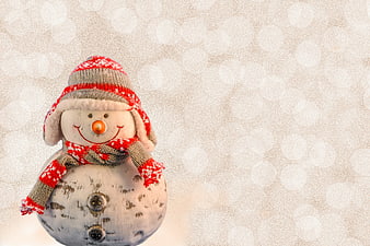 Cute Snowman Ornament with Red Hat and Scarf on Bokeh Background