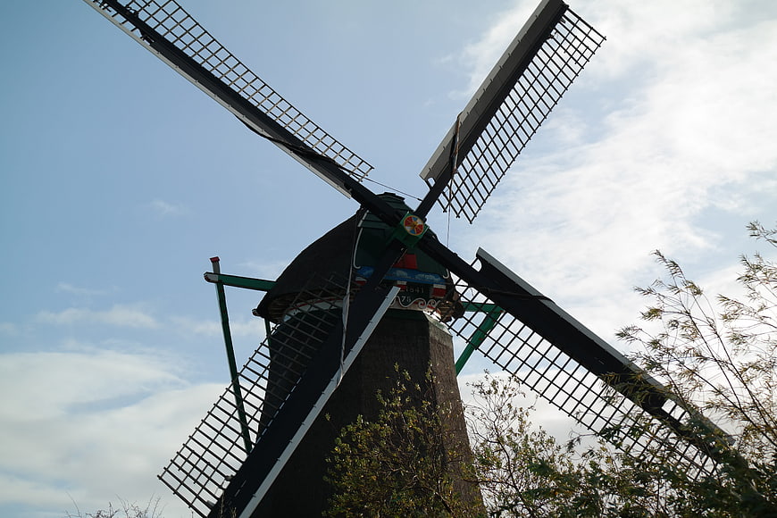 Low angle view of traditional Dutch windmill against blue sky