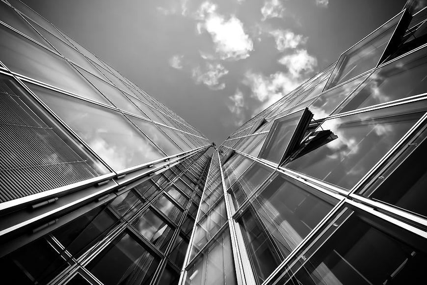 Low angle black and white modern glass skyscraper architecture