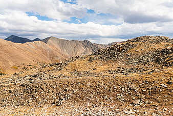 Rugged Rocky Mountain Landscape with Cloudy Sky