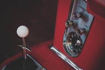 Close-up of vintage red car gear shift and dashboard controls