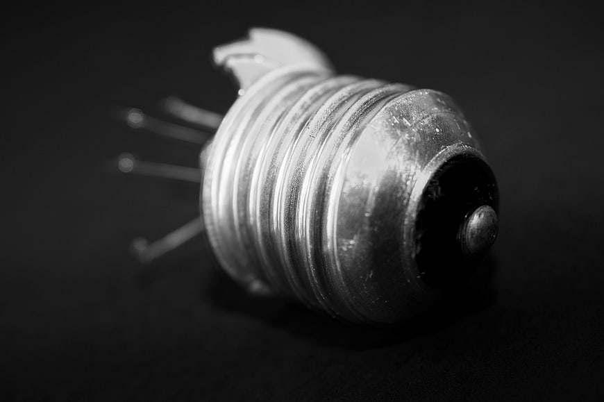Broken metal can with nails in black and white