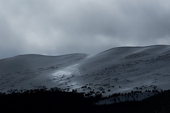 Dark Snowy Mountain Landscape Under Overcast Sky