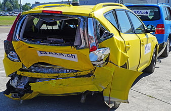 Rear-End Collision Damage on Yellow AXA Test Vehicle