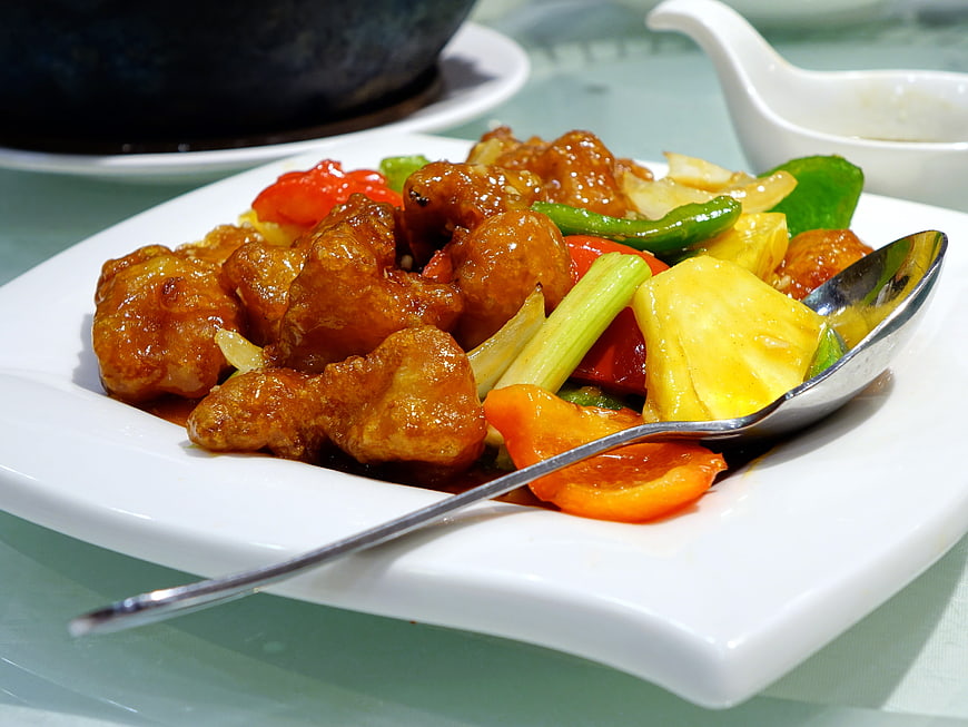 Sweet and Sour Pork with Pineapple and Peppers on White Plate
